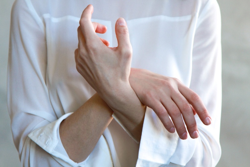 Women's White Long-sleeved Top showing clean healthy nails 8 Best Essential Oils for Nail Care www.manukaoil.com